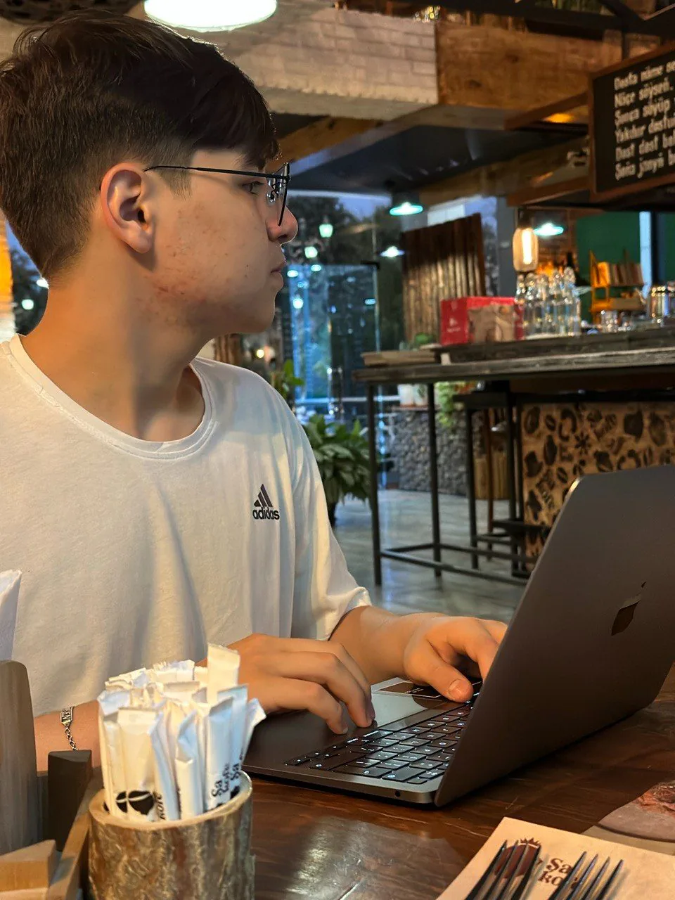 Rovshen working on a laptop